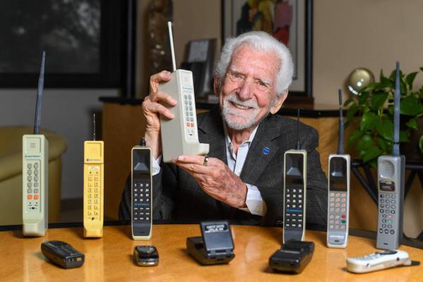 Engineer Martin Cooper holds a co<em></em>ntemporary copy of the original cellphone in Del Mar, California, on March 20, 2023, which he used to make the first cellphone call on April 3, 1973.