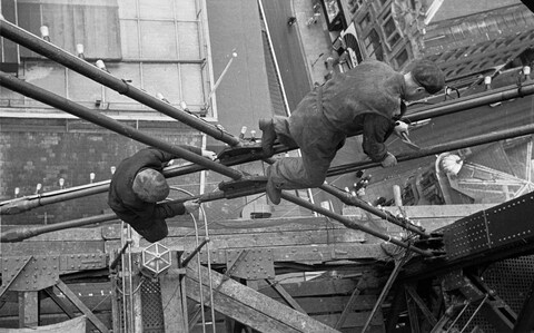 11th July 1953: Co<em></em>nstruction workers balance precariously over the streets of Blackpool over 500 feet below, as they work on the famous Tower. 