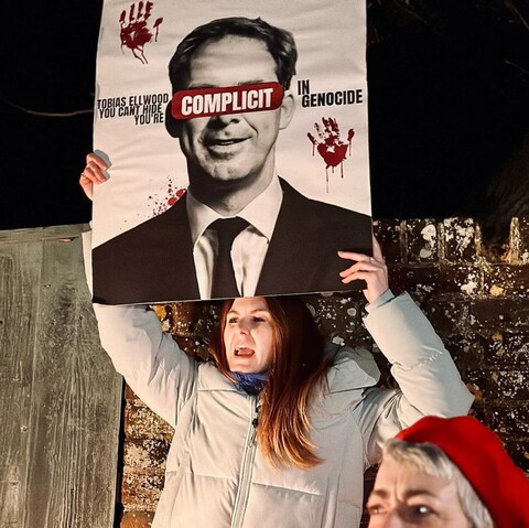 a<em></em>bout 80 activists lined the road outside Mr Ellwood’s home for several hours 