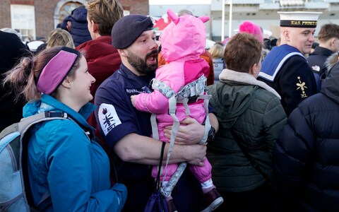 Petty Officer Nicholas Baker holds his daughter Amelia-Rose after the Royal Navy aircraft carrier HMS Prince of Wales returns to Portsmouth Naval ba<em></em>se following a three-mo<em></em>nth deployment to the United States. Picture date: Mo<em></em>nday December 11, 2023