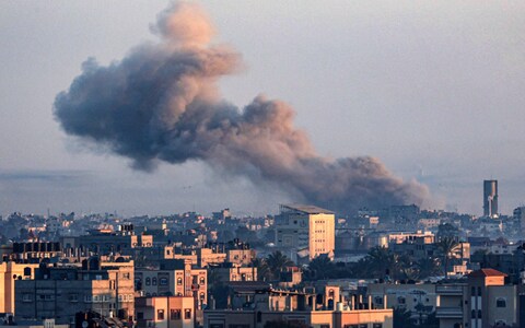 A picture taken from Rafah shows smoke billowing over Khan Yunis 