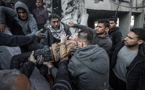 A child is pulled out from rubble after Israeli attacks on the house belo<em></em>nging to the al-Wawawi family