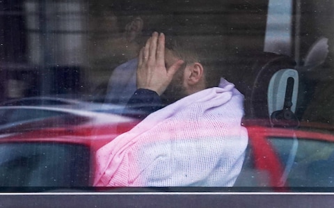 A group of people thought to be migrants are driven away from a Border Force centre