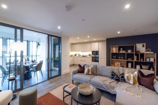 A still image of a stylish living area with a grey couch.