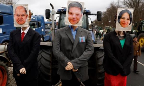 A tractor decorated with dummies with images of (from left) the German chancellor Olaf Scholz, the eco<em></em>nomy minister Robert Habeck, and foreign minister Annalena Baerbock
