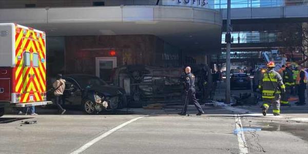 a car on its side rests next to r&t lofts in downtown des moines