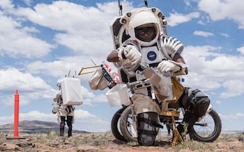 NASA astro<em></em>naut Andre Douglas collects soil samples during the first in a series of four simulated moo<em></em>nwalks in Arizona.