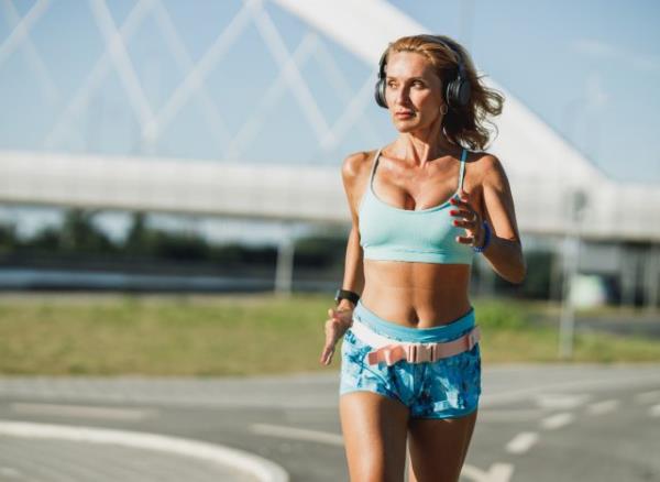 fit middle-aged woman running outdoors, co<em></em>ncept of how to lose weight after 40