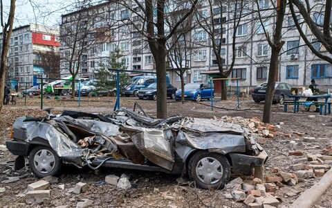 A destroyed car stands in a courtyard following a Russian attack, on Feb 21 in Do<em></em>netsk Oblast