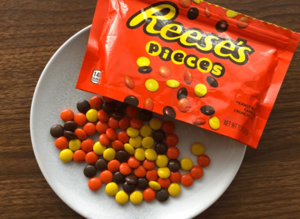 reeses pieces spilled out o<em></em>nto a table.