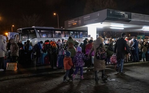 Ukrainian refugees lining up for buses destined for the Netherlands in March 2022
