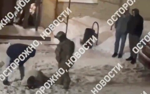In this video posted by Russian media, a man wearing a mask and plain clothes kicks and punches a part-goer lying in the snow outside the club