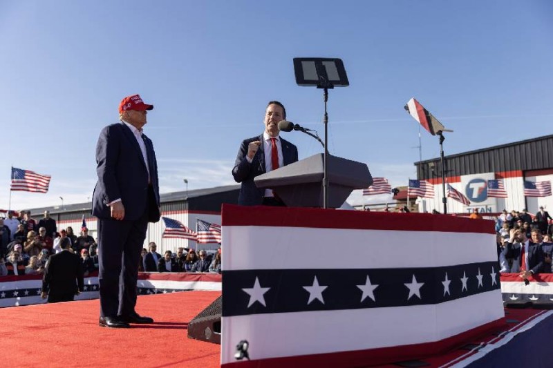 Bernie Moreno, a Republican primary candidate for the U.S. Senate, speaks as former President Do<em></em>nald Trump listens behind him, during a Buckeye Values PAC Rally in Dayton, Ohio on March 16, 2024.