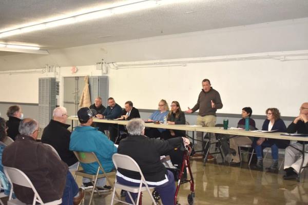 Adrian City Administrator Greg Elliott, standing, discusses some background information with Adrian residents Monday, Feb. 12, 2024, regarding Crimson Holdings LLC, an egg processing facility in east Adrian that has been cited for nuisance odor violations multiple times since starting its business in December 2021.