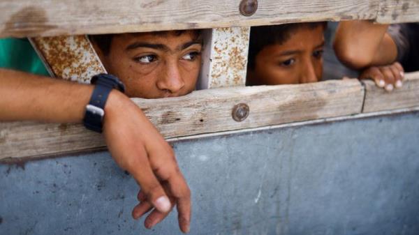Children look into a vehicle carrying the bodies of Palestinians killed in the strike. Pic: Reuters