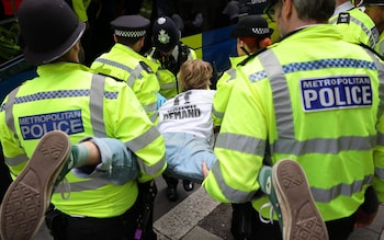 A protester is carried away by police