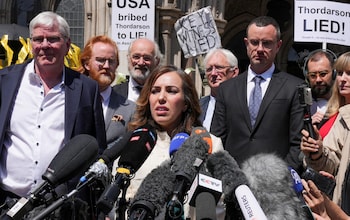 Stella Assange, the wife of WikiLeaks founder Julian Assange, speaks to the media outside the High Court on Mo<em></em>nday wher<em></em>e dozens of protesters  cheered loudly as the court's decision was read out