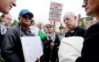 The Archbishop of Canterbury with Palestinian protestors outside Gloucester Cathedral in May 2024