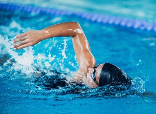 swimmer swimming laps, demo<em></em>nstrating when to work out while intermittent fasting