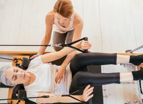 woman doing supine arms Pilates exercise