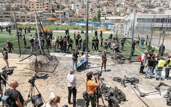 Druze community members pay tribute to the victims at the site of a rocket attack in the Golan Heights city of Majdal Shams
