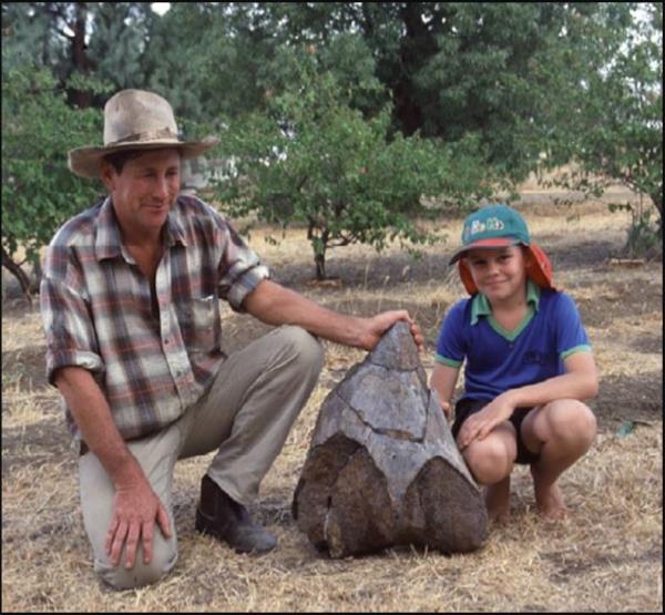 Dave Elliott and his son Harry proudly display the lower part of the thighbone of the sauropod.