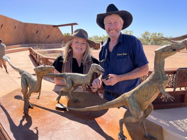 David Elliot and a woman posing next to model dinosaurs