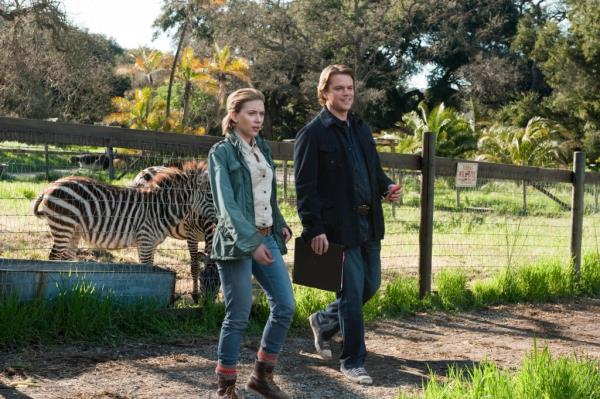 Matt Damon and Scarlett Johansson walk in front of a zebra in 