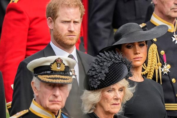 FILE - Britain's King Charles III, from bottom left, Camilla, the Queen Consort, Prince Harry and Meghan, Duchess of Sussex watch as the coffin of Queen Elizabeth II is placed into the hearse following the state funeral service in Westminster Abbey in central Lo<em></em>ndon Mo<em></em>nday Sept. 19, 2022.