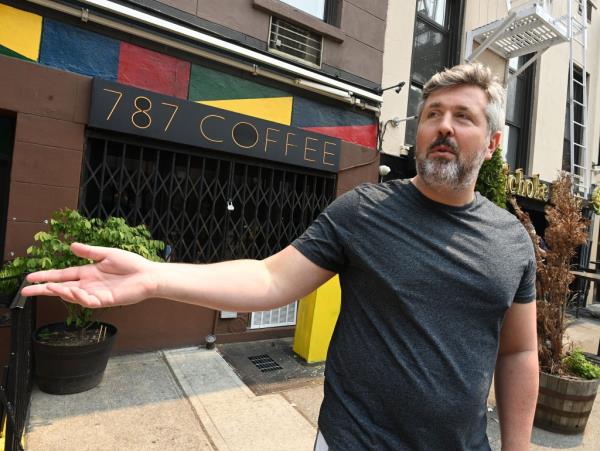 Man standing in front of closed 787 Coffee Co. location