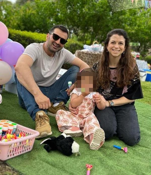 Noga Guttman with her husband and young child at a party