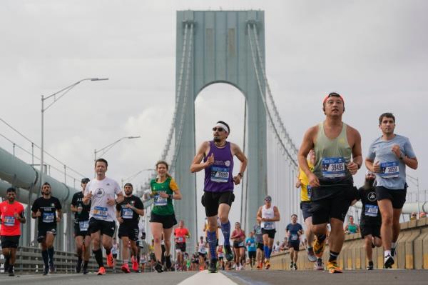 Runners cross the Verrazzano Bridge after the start of the 2022 NYC Marathon. The race goes through all five boroughs before finishing in Manhattan.