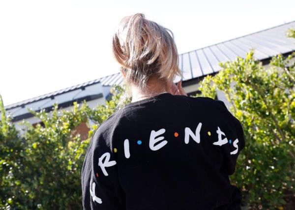 A fan wearing a Friends cardigan