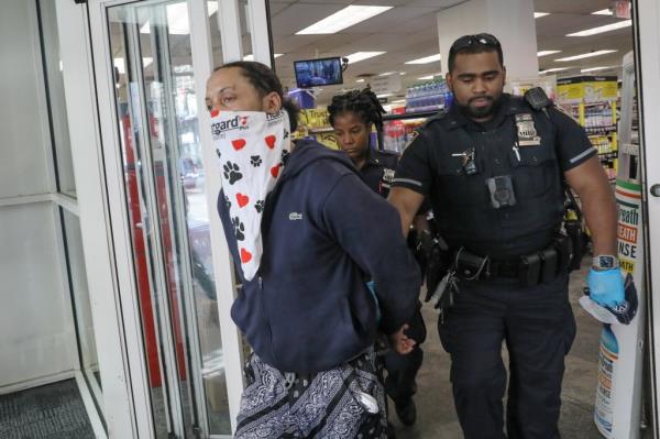 NYPD officers arresting a serial shoplifting suspect at a CVS Pharmacy in Manhattan on May 21, 2022.