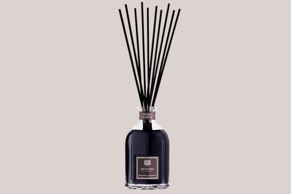 Image of a diffuser, a black bottle with sticks inside 