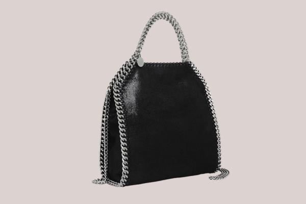 A black Stella McCartney bag with a silver chain strap