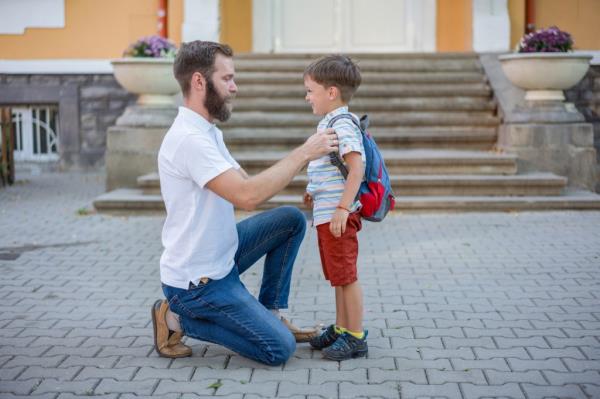 Young father walking his son to school.