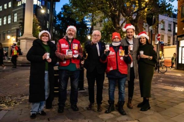 Christmas team (from left): Big Issue fro<em></em>ntline worker Daisy Hampson, vendor Jon Gregg, Lord John Bird, vendor Kelvin Gregory, actor and Big Issue ambassador Daniel Mays, and Big Issue fro<em></em>ntline worker Leventica Paun (Picture: Louise Haywood-Schiefer)