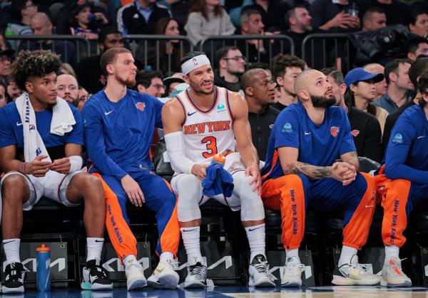 New York Knicks guard Josh Hart rubs his knee while on the bench during the second quarter.