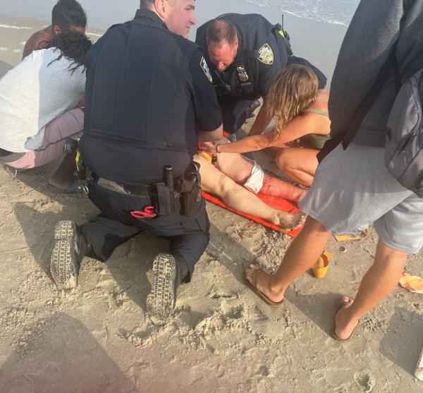 Tatyana Koltunyuk is treated by emergency perso<em></em>nel after she was bitten by a shark.