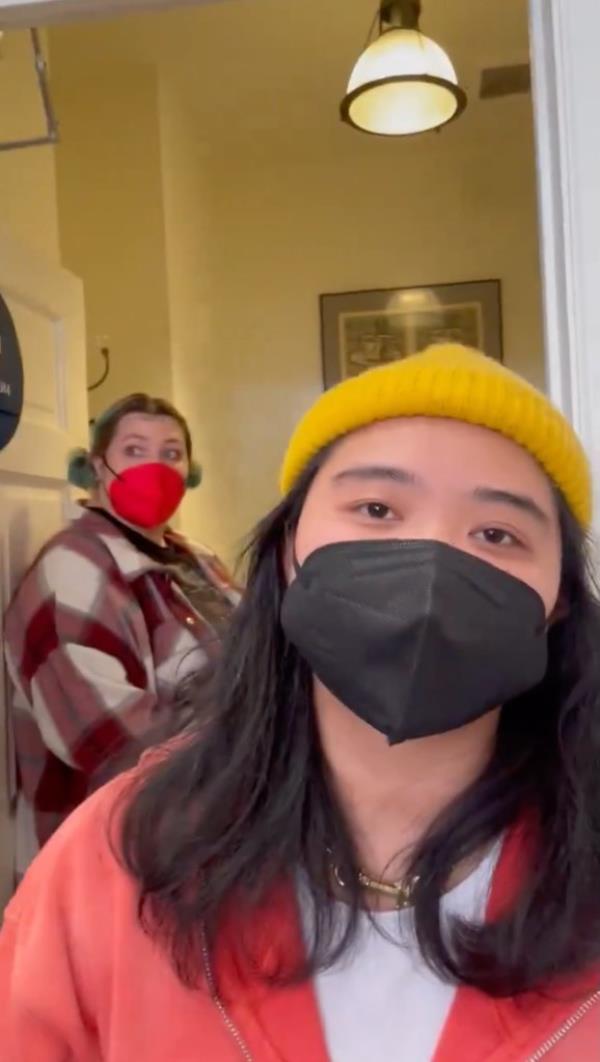 Three workers blocked the woman, who was looking to film the graffiti inside. 