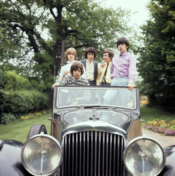 The Rolling Sto<em></em>nes — seen here in a vintage car in 1964 — were “not much more than unbrushed Beatles dressed in play-clothes” before they met the women who would shape and influence them. 