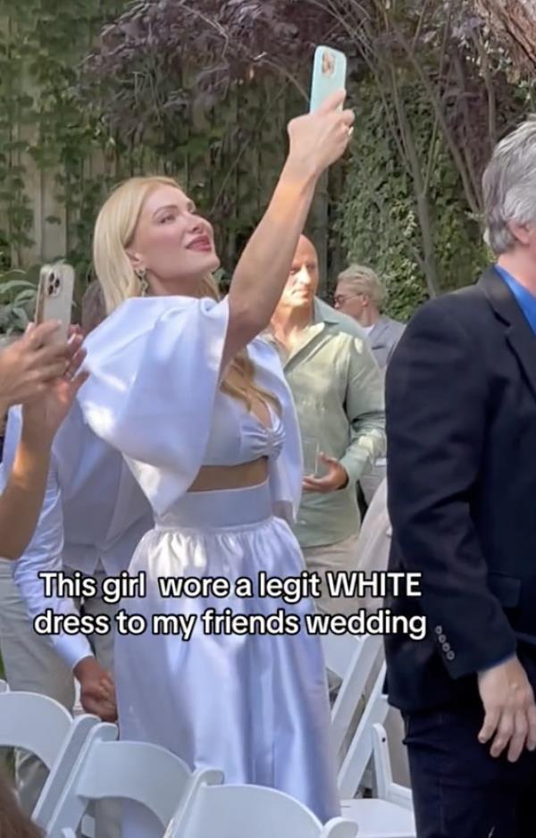 A screenshot of wedding guest Lana Kaufman, a married mom of four from Texas, wearing a white dress to a friend's nuptials.