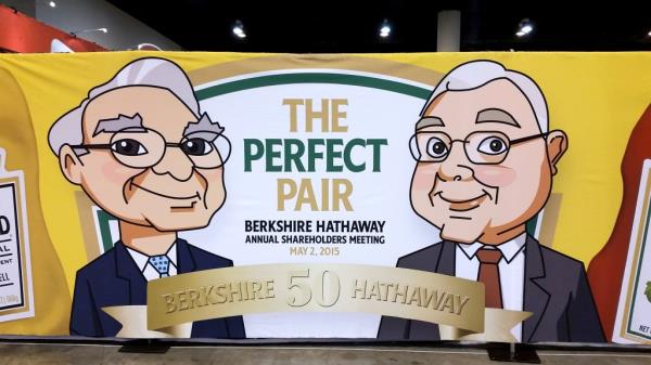 This graphic featuring a cartoon Munger (left) and Buffett (right) was displayed during Berkshire's 2015 annual meeting -- the firm's 50th anniversary.