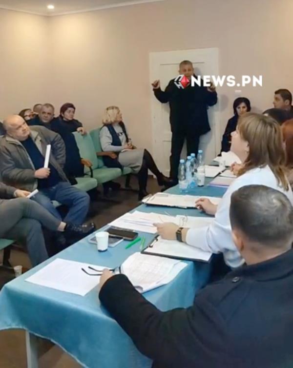 Deputy Serhiy Batryn, circled in red, seen holding multiple hand grenades moments before triggering explosions during a council meeting in Ukraine
