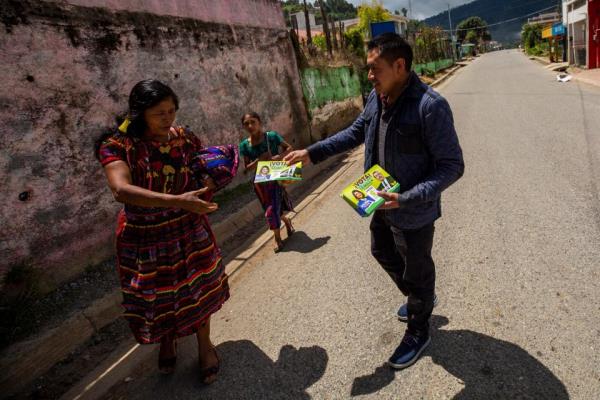 Bartolo Baten distributed political leaflets of Bernardo Are<em></em>valo seeking support from members of his Mayan community in Chiul, Guatemala on Aug. 13, 2023. Baten had presented the presidential candidate with a gift from the community in Quiche, Guatemala the previous day wher<em></em>e the candidate held a rally ahead of the runoff election on Aug. 20, 2023.