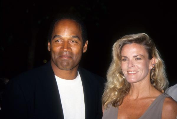 O.J. Simpson and Nicole Brown Simpson pose at the premiere of the 