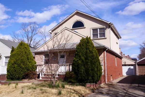 Exterior view of a house at 26-07 160th St. in Queens, NY, allegedly occupied by squatters and subject of a property dispute involving homeowner Adele Andaloro