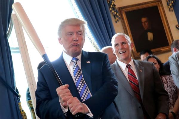 Vice President Mike Pence laughs as U.S. President Do<em></em>nald Trump holds a ba<em></em>seball bat as they attend a Made in America product showcase event at the White House in Washington, U.S., July 17, 2017.