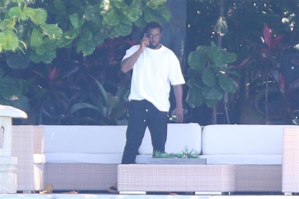 Diddy on his phone, amid the raids from Feds. 